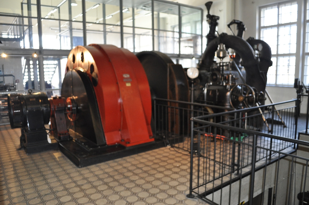 Der Maschinensatz des Forstsee-Kraftwerkes: Rechts die Zwillings-Pelton-Turbine mit vier Düsen. In der Mitte dient ein 3,8t schweres Schwungrad zur Stabilisierung der Drehzahl und der Netzfrequenz. Links im orangefarbenen Gehäuse erzeugt der Generator im Vollbetrieb eine Leistung von bis zu 2,4MW. Der Maschinensatz des Forstsee-Kraftwerkes: Rechts die Zwillings-Pelton-Turbine mit vier Düsen. In der Mitte dient ein 3,8t schweres Schwungrad zur Stabilisierung der Drehzahl und der Netzfrequenz. Links im orangefarbenen Gehäuse erzeugt der Generator im Vollbetrieb eine Leistung von bis zu 2,4MW.